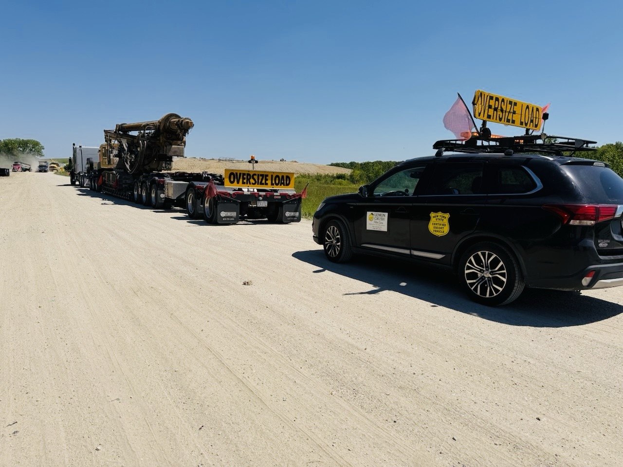 Drill rig on RGN with certified escort vehicle